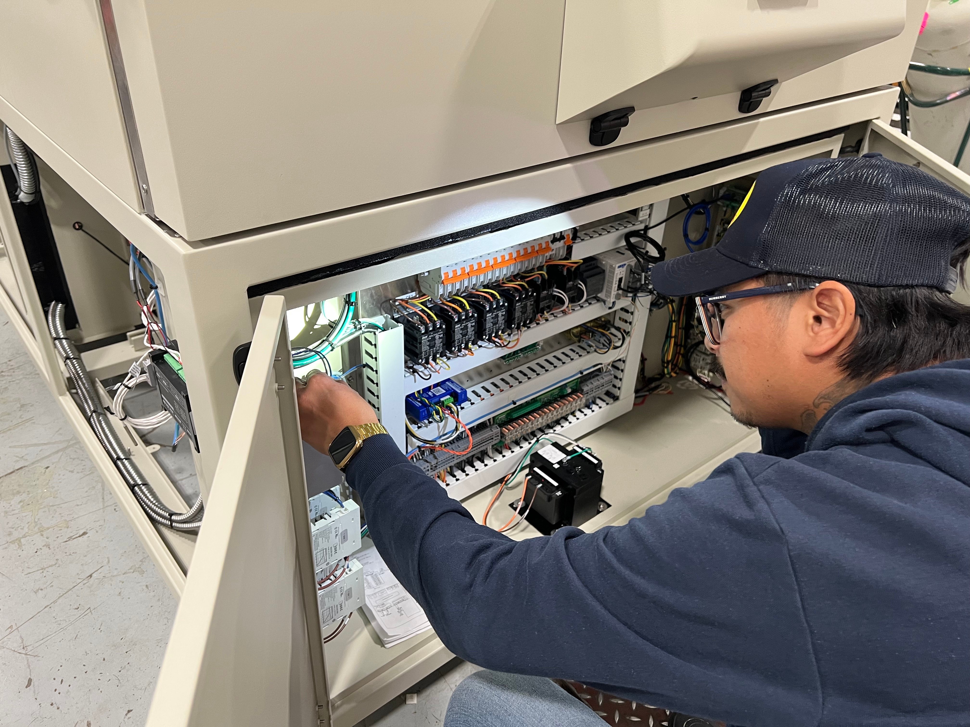 Technician looking closely at a chamber